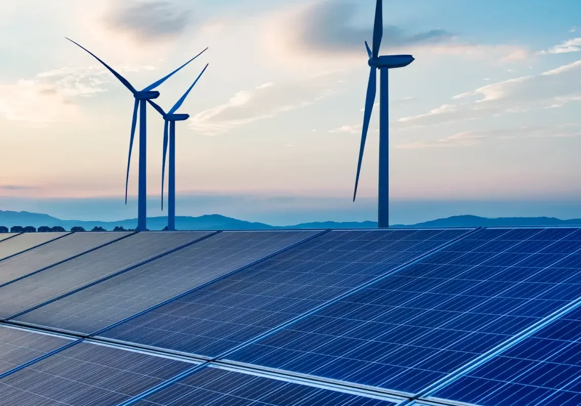 Solar panels and wind turbines under a blue sky, illustrating renewable energy sources.