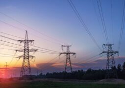 Sunset behind steel transmission towers