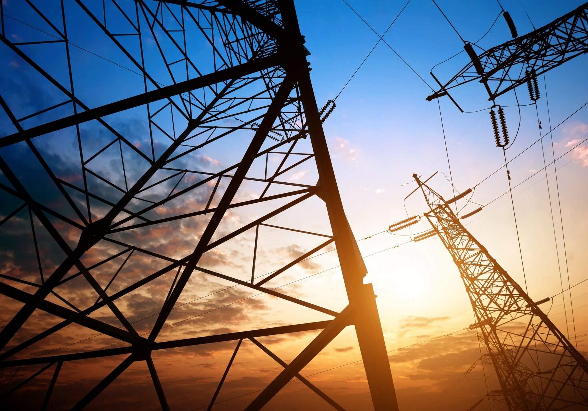 A view of some power lines at sunset.