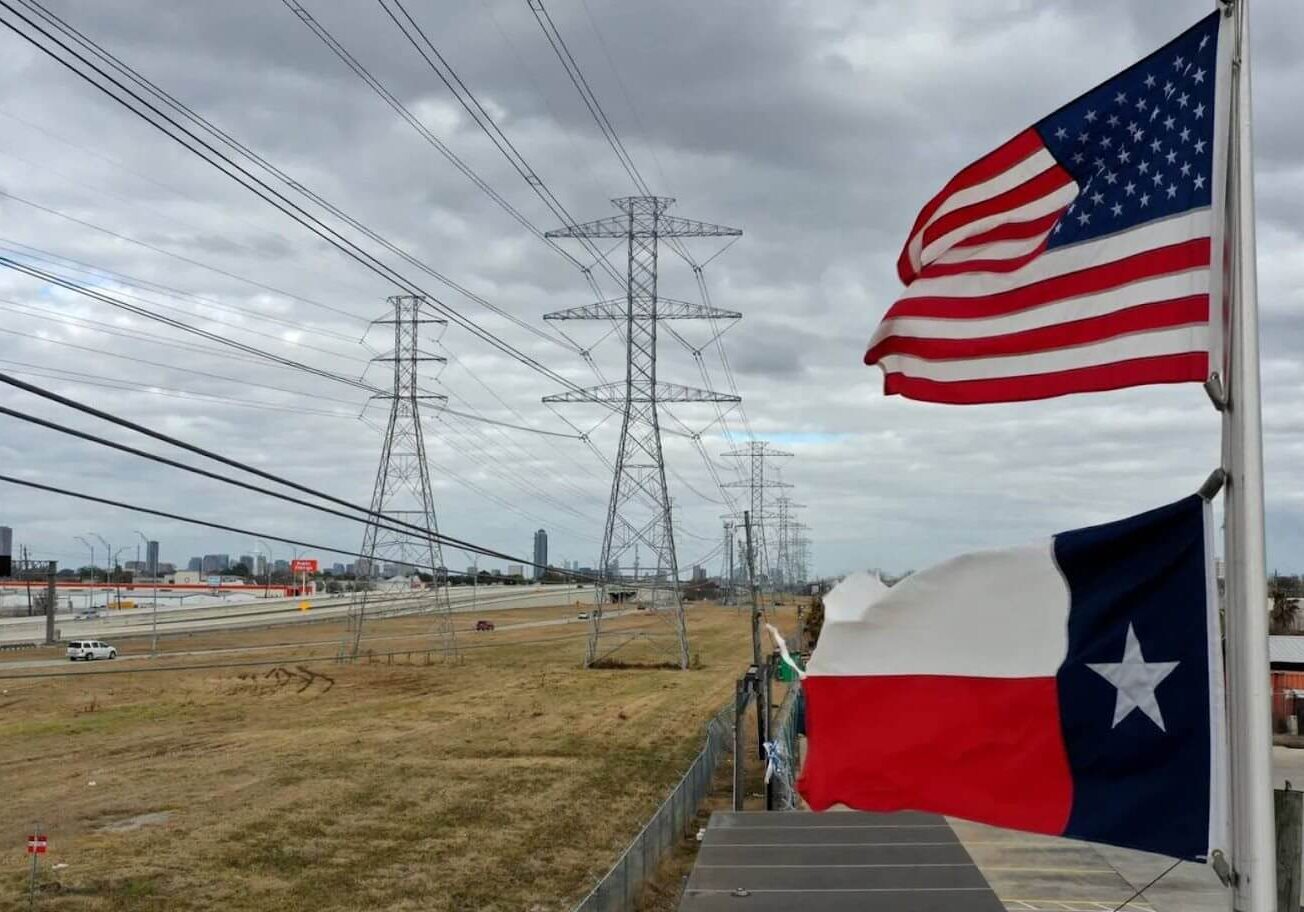 American and Texas flags near power pylons